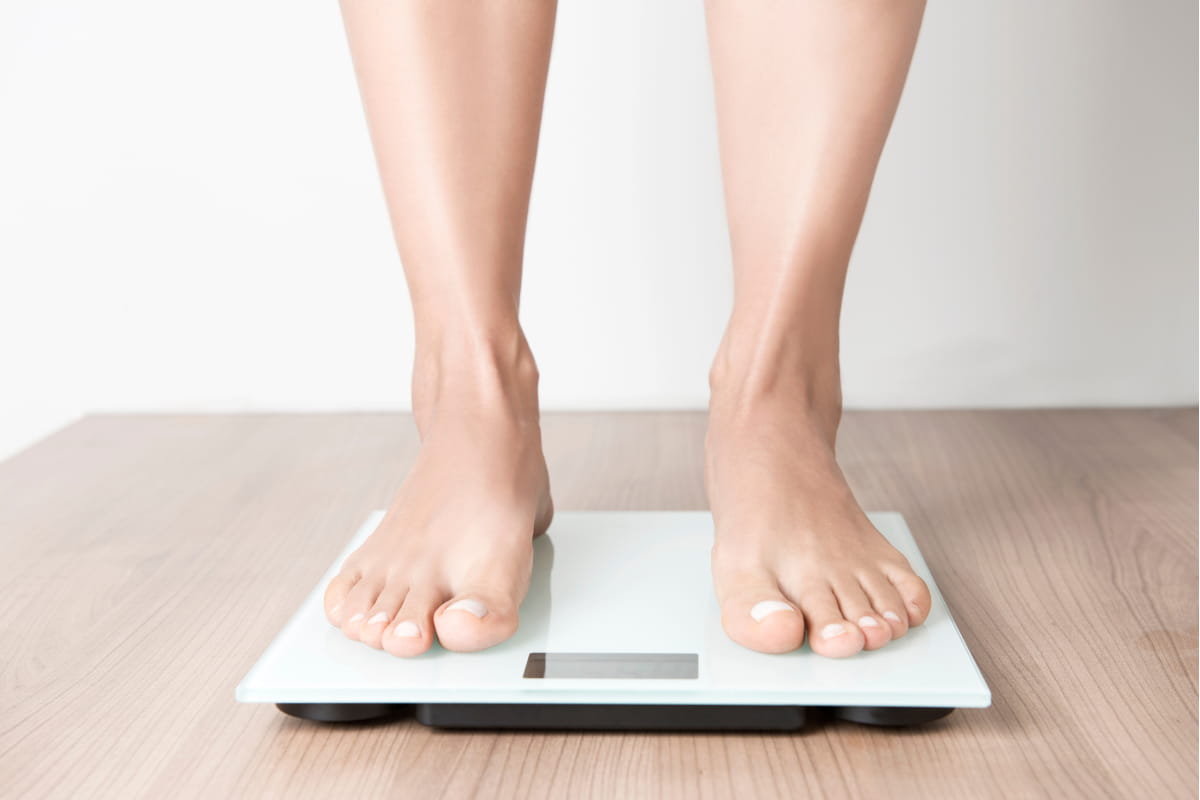 standing on scales to measure weight